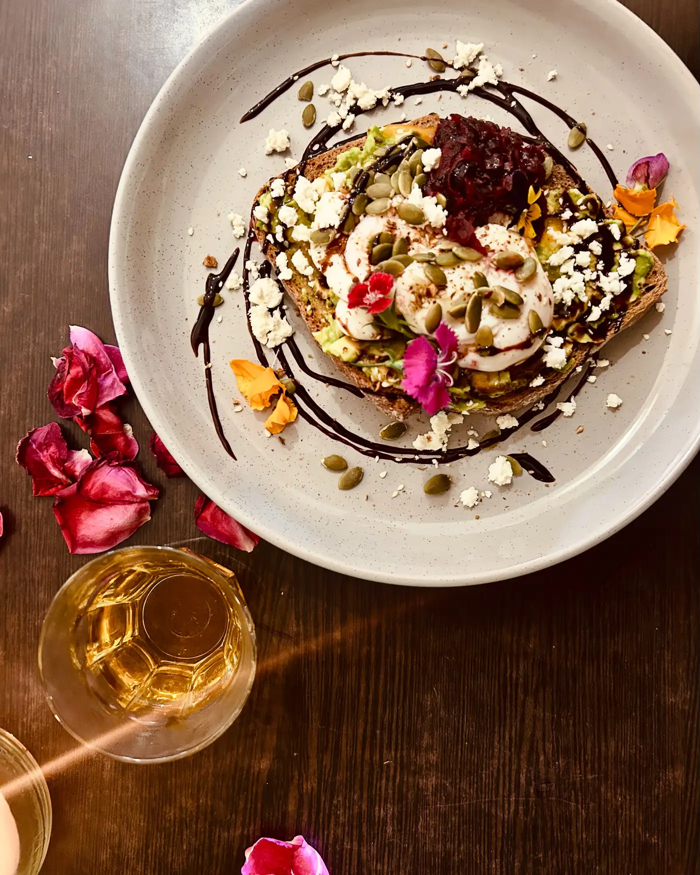 Avocado toast with feta, beetroot relish, pumpkin seeds and edible flowers