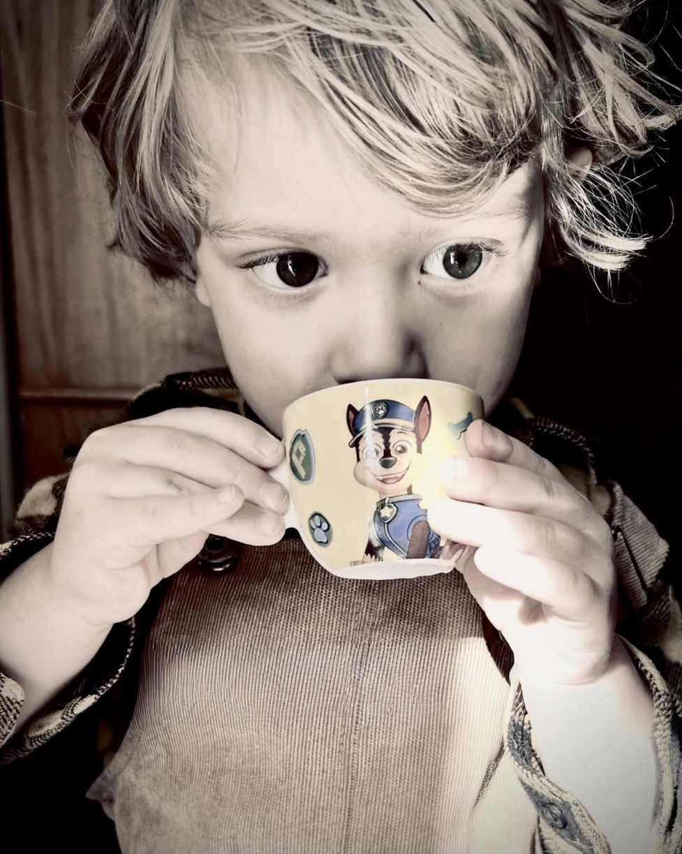 Young child enjoying a babychino at Nature's Table Cafe