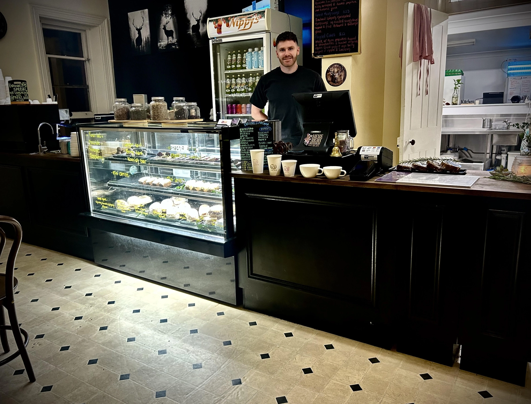 Nature's Table Cafe counter with fresh food display cabinet and friendly staff