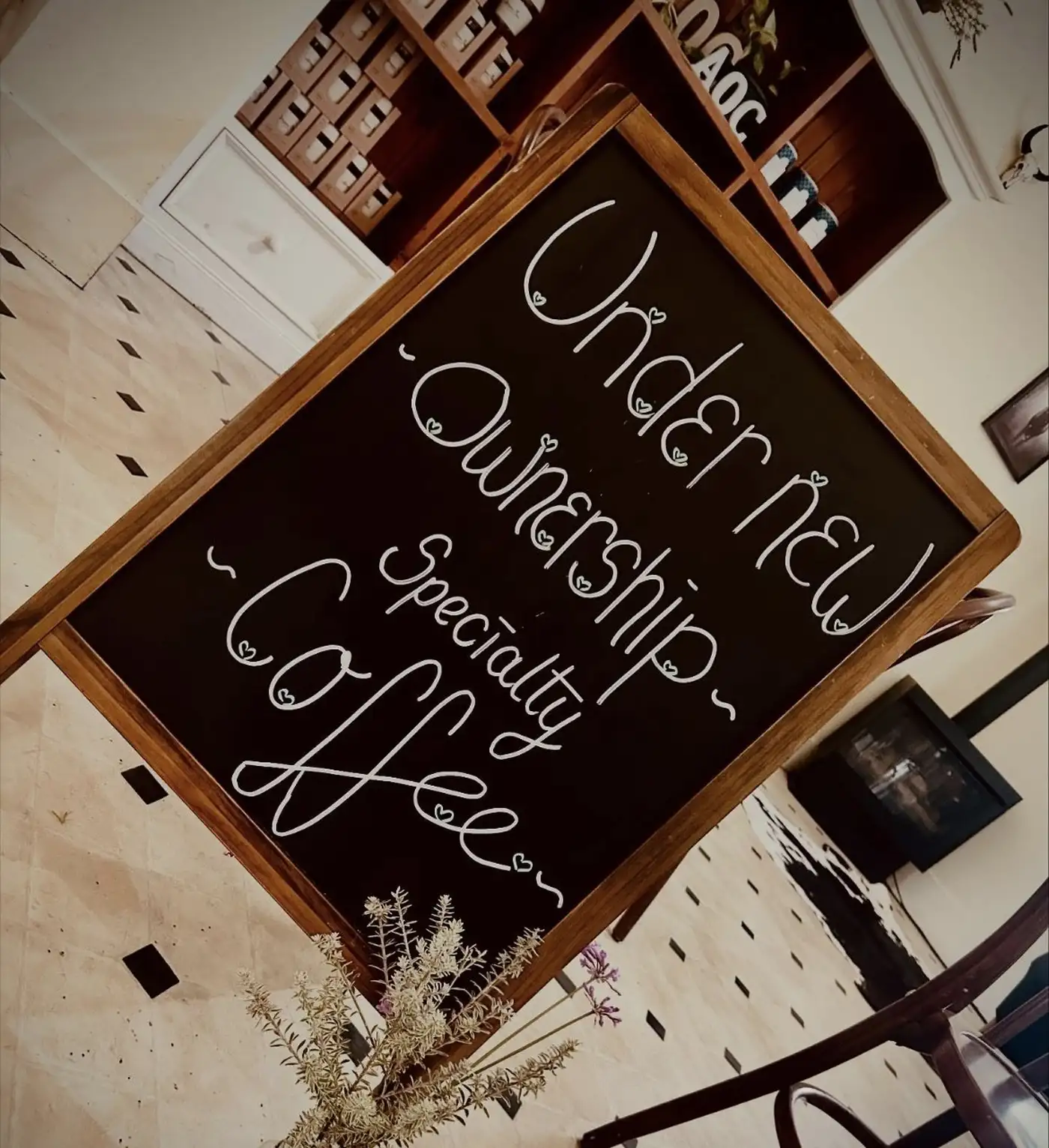 Nature's Table Cafe interior with specialty coffee chalkboard and cosy atmosphere