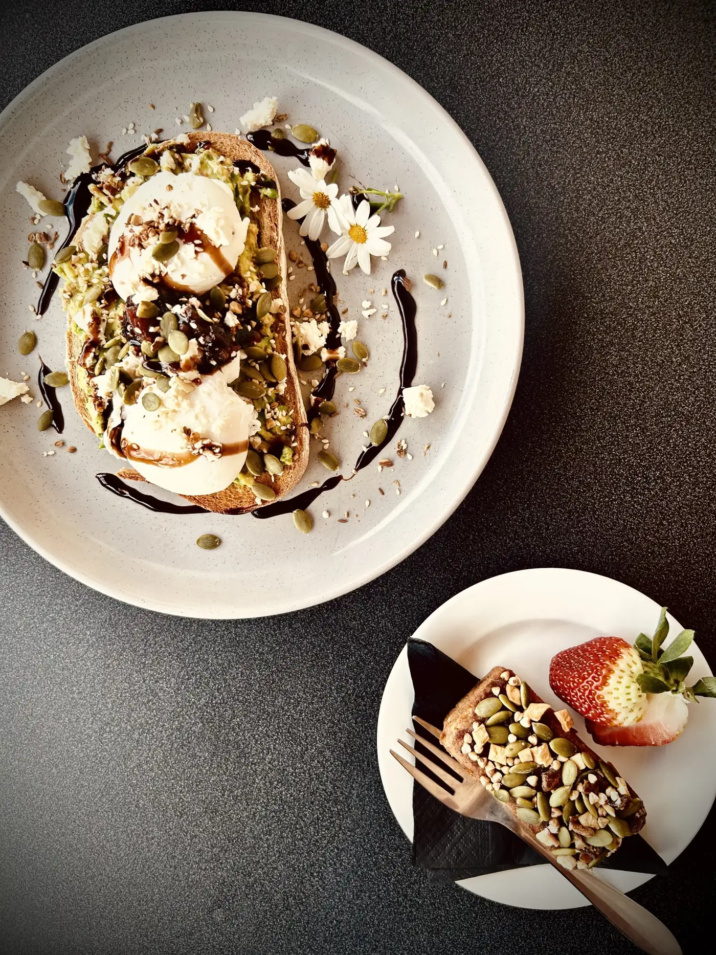 Poached eggs on toast with balsamic glaze, seeds and a chocolate slice with strawberry